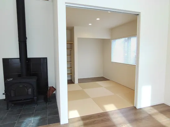 薪ストーブを囲む、吹抜けリビングのある家